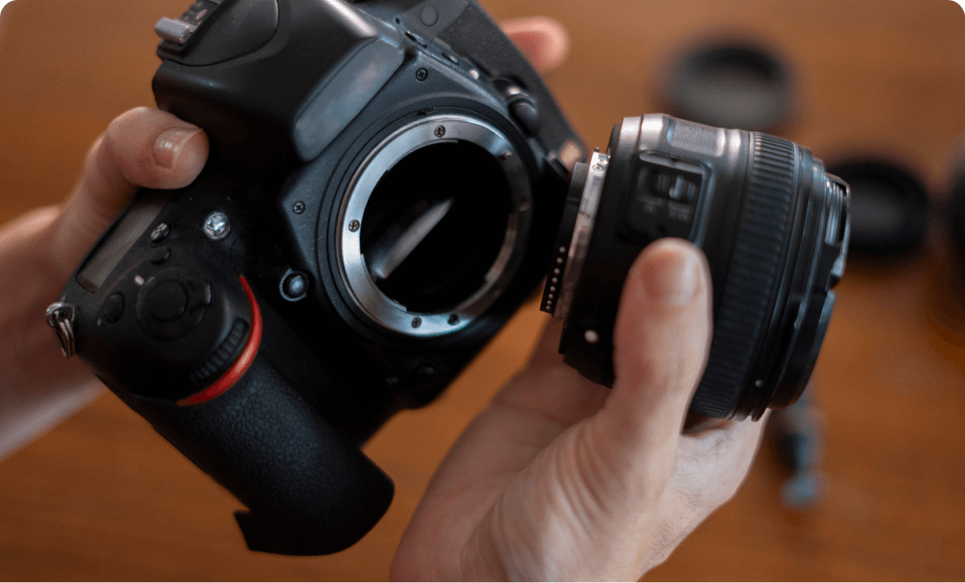 close up of a DSLR camera being assembled, the lens is separated from the body