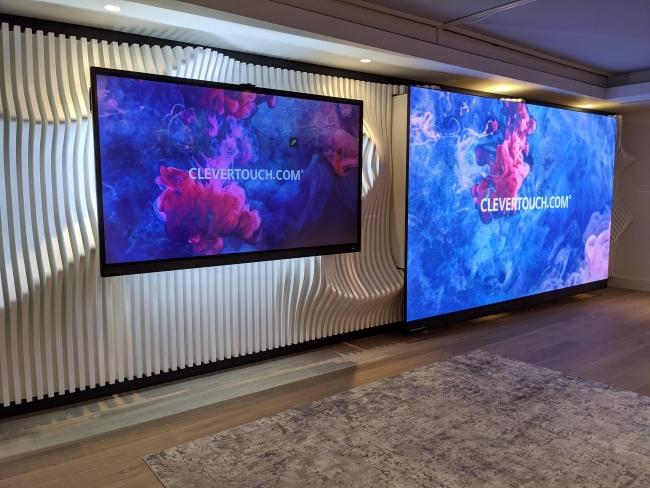 image of two projector screens against a wall. The screens show a colorful abstract background of ink in water with "clevertouch.com" in the middle of each screen